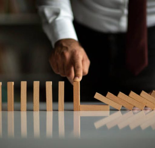 Businessman Stop Domino Effect. Risk Management and Insurance Concept Businessman Stop Domino Effect. Risk Management and Insurance Concept